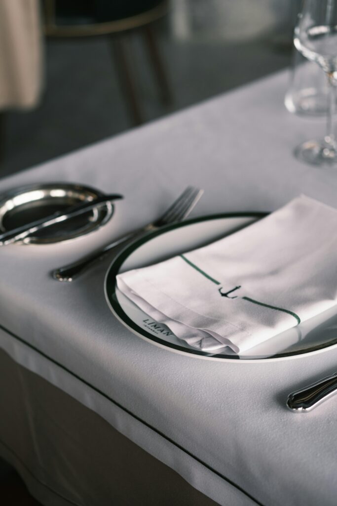 Close-up of a sophisticated restaurant table setup with cutlery and napkin.