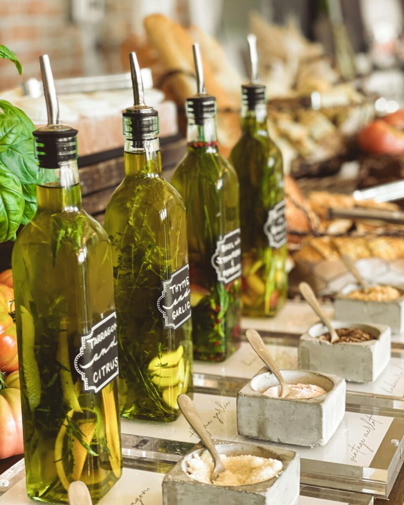 Infused olive oil bottles with herbs and spices on a gourmet kitchen counter.